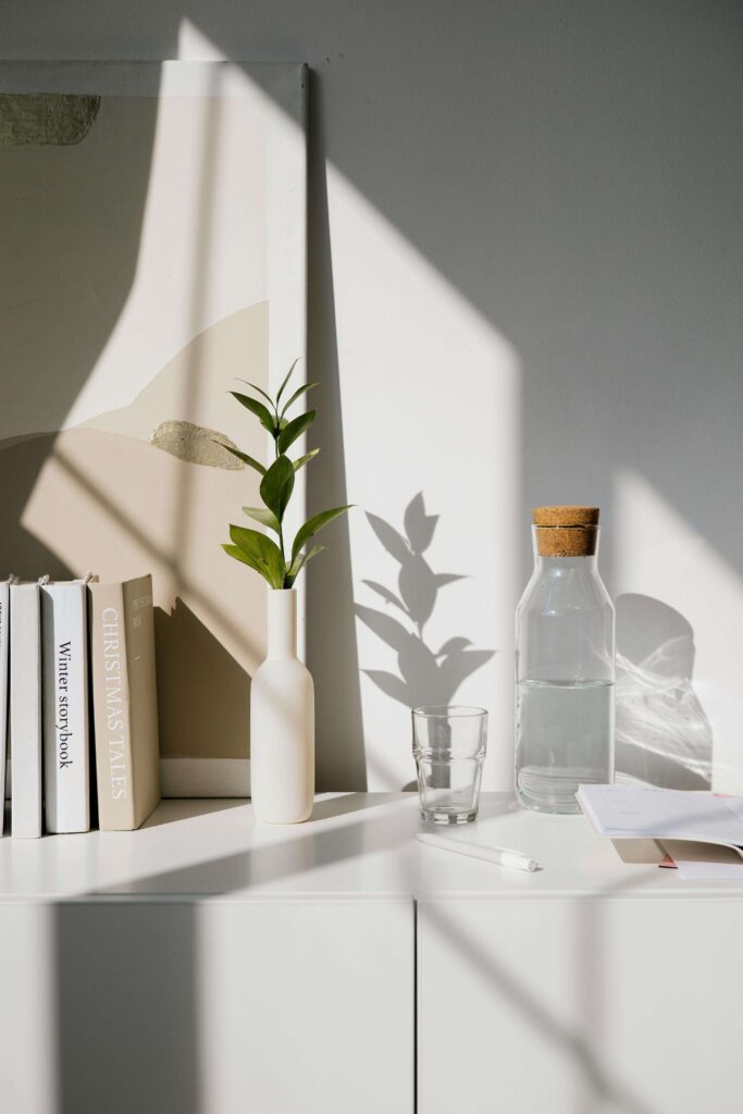 Styled shelf with books and glass bottle.